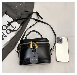 Detailed macro view of black box bag showing size comparison with a smartphone