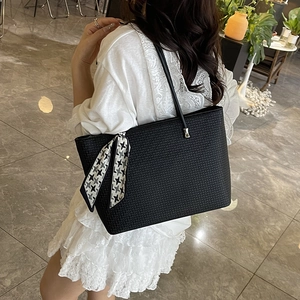 Fashionable black woven tote bag with houndstooth scarf detail for daily commute