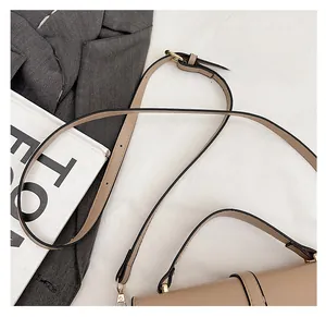 Detail of adjustable khaki PU leather shoulder strap with elegant gold metal buckles
