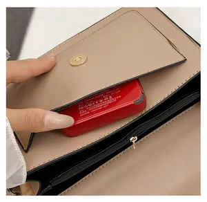 Detail view of khaki PU leather bag showing front pocket capacity and magnetic buckle