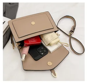 Interior view showing the large storage capacity of this beige PU leather shoulder bag