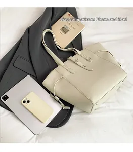 Detailed size comparison of the cream tote bag with an iPad and smartphone