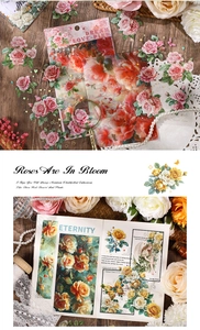 Macro shot of 4PCS vintage rose and butterfly stickers on a rustic wood table with pearls