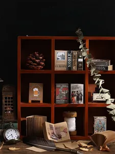 Detailed close-up of vintage kraft scrapbook paper set displayed in wooden shelf