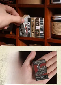Miniature vintage locomotive scrapbooking paper held in hand for scale comparison