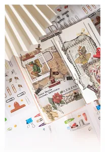 Detail of vintage musical score paper with floral stickers and metal stationery clips