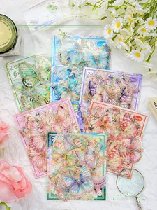 Detail of holographic laser gold butterfly stickers with shell luster for DIY journaling