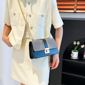 Navy blue and grey patchwork crossbody bag with gold chain and square metal clasp