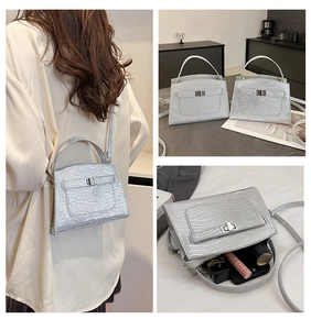 Detail of silver glitter mini bag showing textured surface and interior capacity for essentials