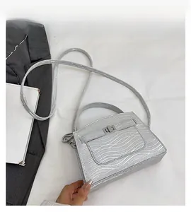 Silver wavy textured handbag with metallic twist lock and slim shoulder strap detail