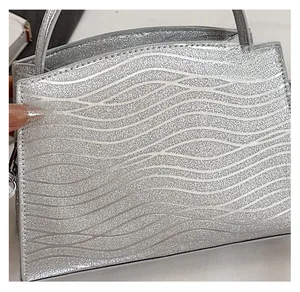 Close-up of silver sequin fabric with elegant wave patterns and metallic finish