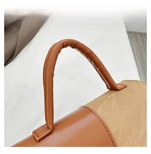 Detailed view of dual-texture stitching and reinforced handle on the beige shoulder bag