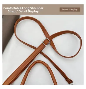 Detail view of caramel brown handbag featuring adjustable silver buckle and smooth handle