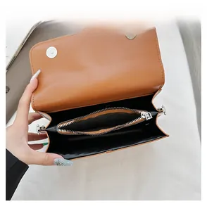 Interior view of the brown leather handbag with dual magnetic snaps and zip compartment