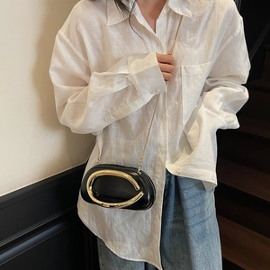Classic black round clutch bag with large gold metal handle and slim chain strap for women