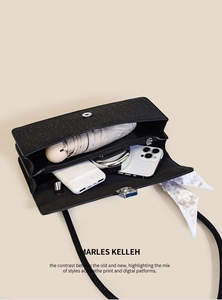 Macro view of black striped shoulder bag interior showing large storage capacity