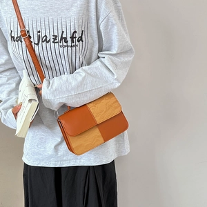 Stylish brown and beige patchwork crossbody bag shown with model for casual fashion look