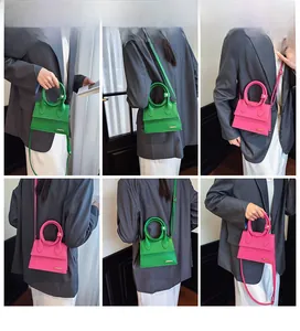 Detailed views of mini leather handbags with round handles in green and pink colors