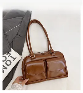 Details der karamellfarbenen Unterarmtasche mit zwei Vordertaschen und silbernen Beschlägen