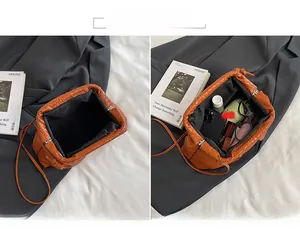 Detailed view of brown woven bag interior showing capacity for sunglasses and phone