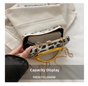 Leopard print box clutch showing spacious interior for phone, lipstick with chain strap