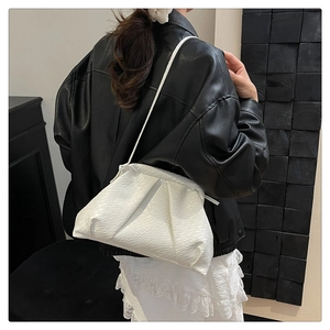 Detail of white woven shell bag showing its unique cloud pleats and leather texture