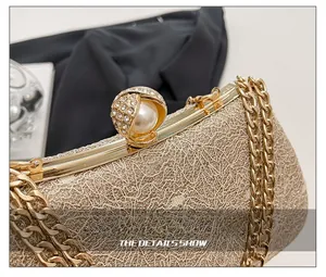 Detail of gold woven clutch with pearl clasp and chunky chain strap for luxury parties