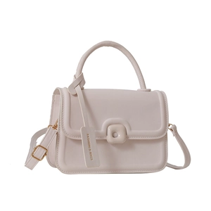 Minimalist light pink crossbody bag with faux leather finish and square buckle
