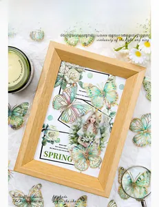 Detail of laser gold foil butterfly stickers and girl motif on a rustic wooden frame