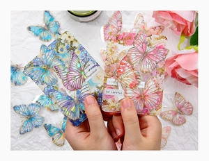 Macro view of laser gold foil butterfly stickers with floral and vintage label designs