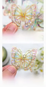 Macro shot of butterfly PET stickers with gold holographic edges and iridescent finish