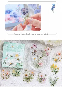 Close-up of waterproof PET flower stickers featuring daisies and green leaves for DIY crafts