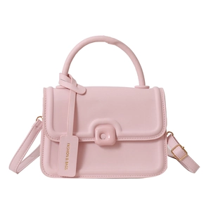 Pink jelly crossbody bag with top handle and gold hardware on white background