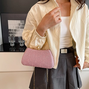 Chic pink textured box clutch bag with gold chain strap and pearl clasp detail