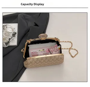 Macro view of champagne gold evening bag with rhinestone buckle and chain strap detail