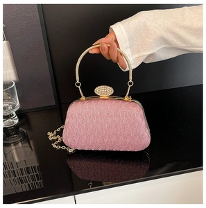Detailed close-up of pink sequined evening bag with crystal clasp and gold chain