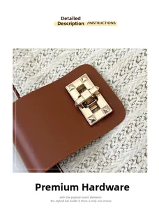 Close-up of brown leather flap with gold pyramid stud lock on woven straw handbag