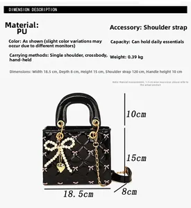 Detail of black patent leather mini bag with quilted pattern and pearl bow charm