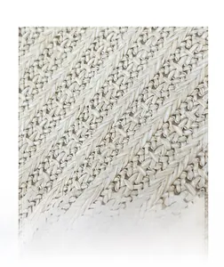 Macro shot of natural straw woven fabric detail with diagonal texture on tote bag