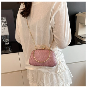 Detail of pink sequin evening bag with gold metal frame and sparkling rhinestone clasp