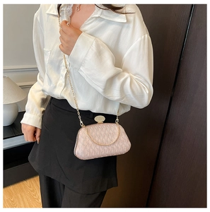 Detailed side view of pink glitter evening bag with gold chain and rhinestone clasp