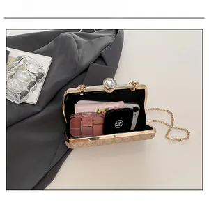 Detail showing the internal storage capacity of a sequin evening bag with a jewel clasp