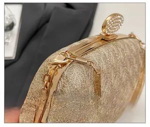Close-up of champagne gold clutch lock with diamonds and textured metal frame
