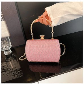 Pink sequin evening bag with round gold handle and rhinestone clasp detail