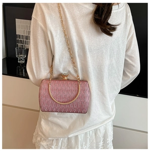 Detailed view of a pink floral sequin evening clutch bag with golden chain strap