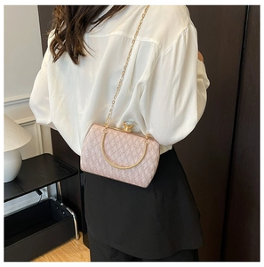 Pink pearl texture clutch bag with gold chain strap and jewel clasp shown on model