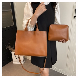 Detail of caramel brown leather tote bag set with detachable strap and inner pouch