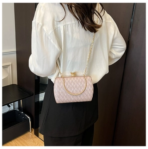 Rear view of pink sequin evening bag with gold metal handle and chain on model