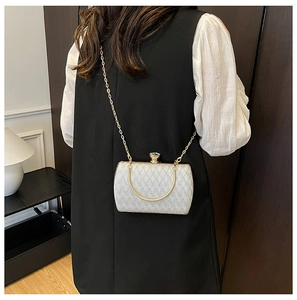 Silver sequin evening bag with gold chain strap and crystal clasp shown in use