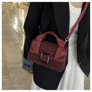 Detail of leopard print handbag with knotted handle and iconic black square buckle